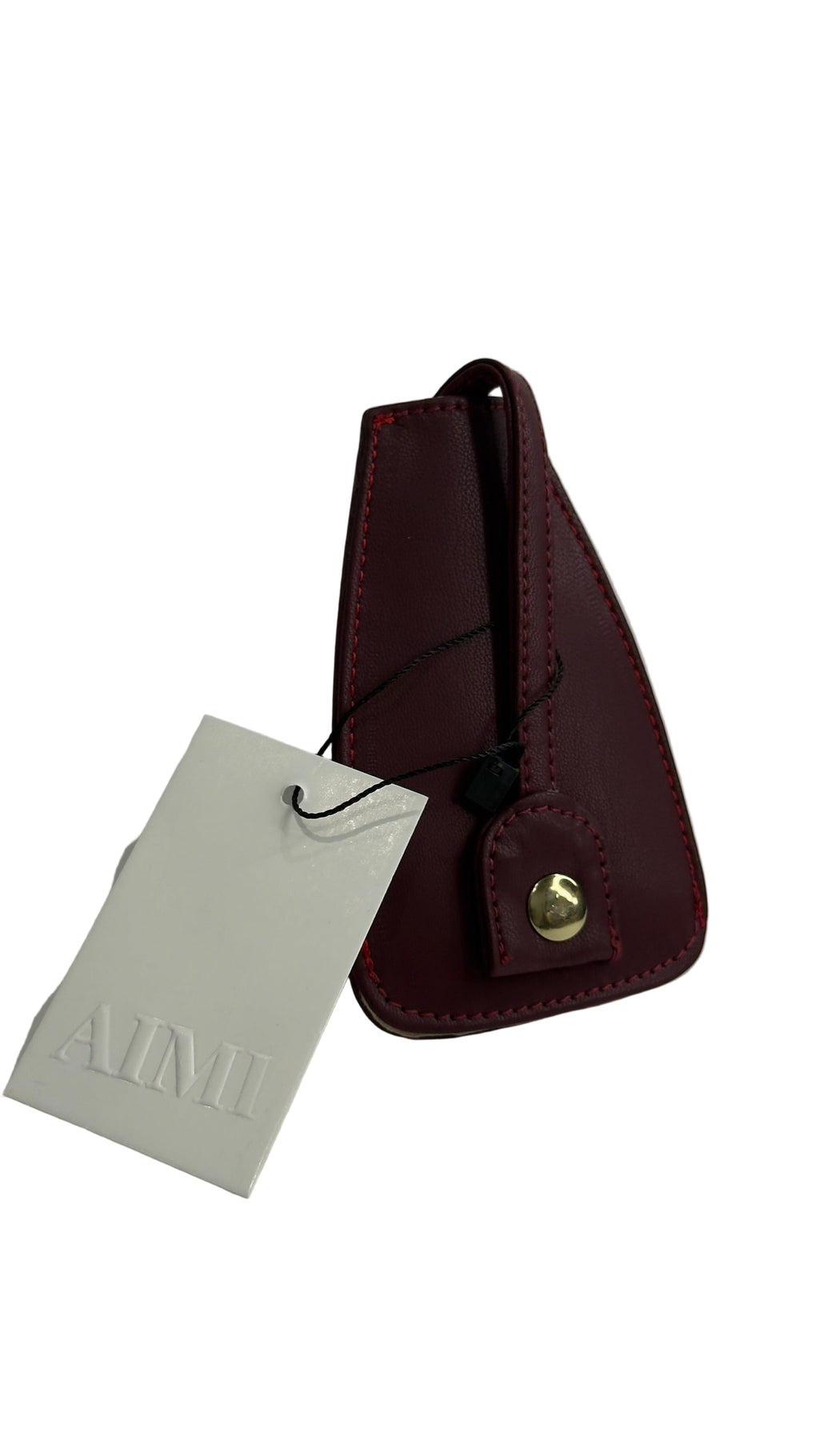 Burgundy leather key holder with gold accent on a white background