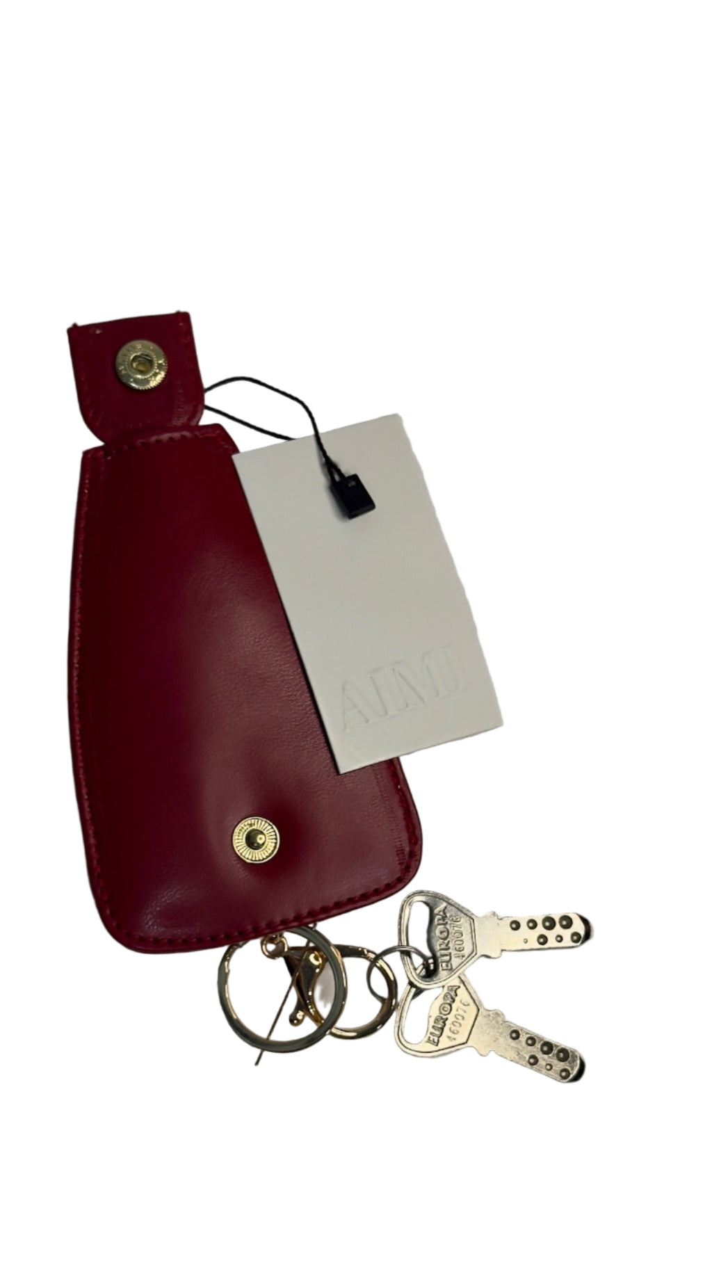 Red leather key pouch with keys and a tag 